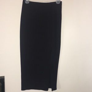 Below the knee black skirt with slit.